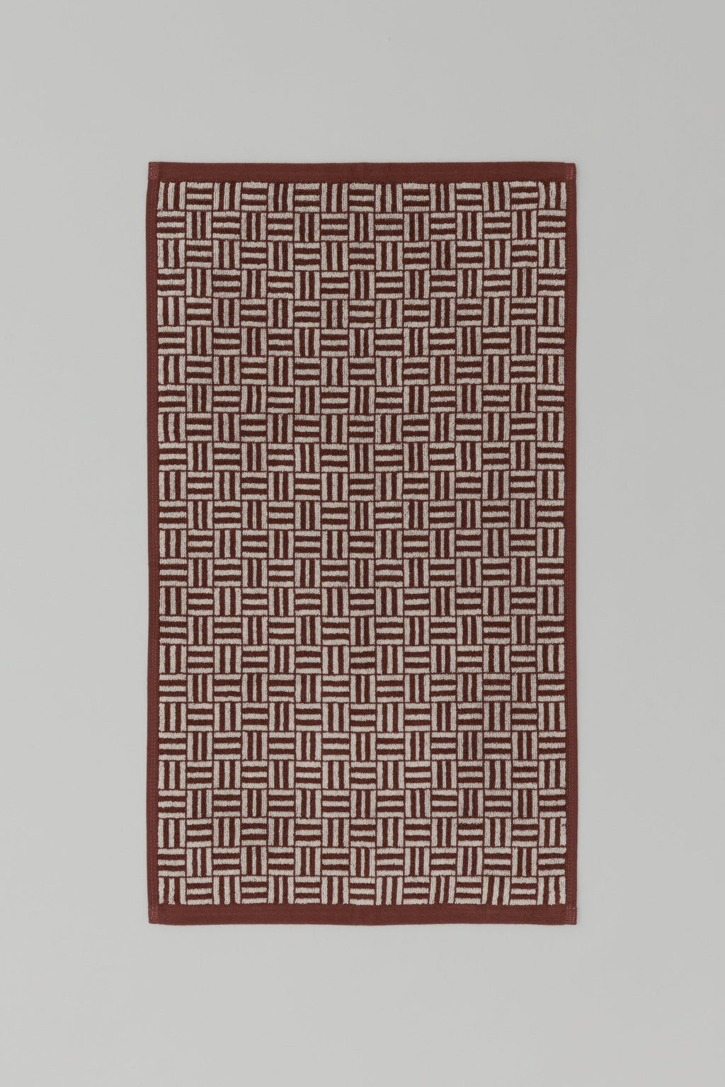 BAINA Torrens Hand Towel in Mudbrick & Crème, flat lay