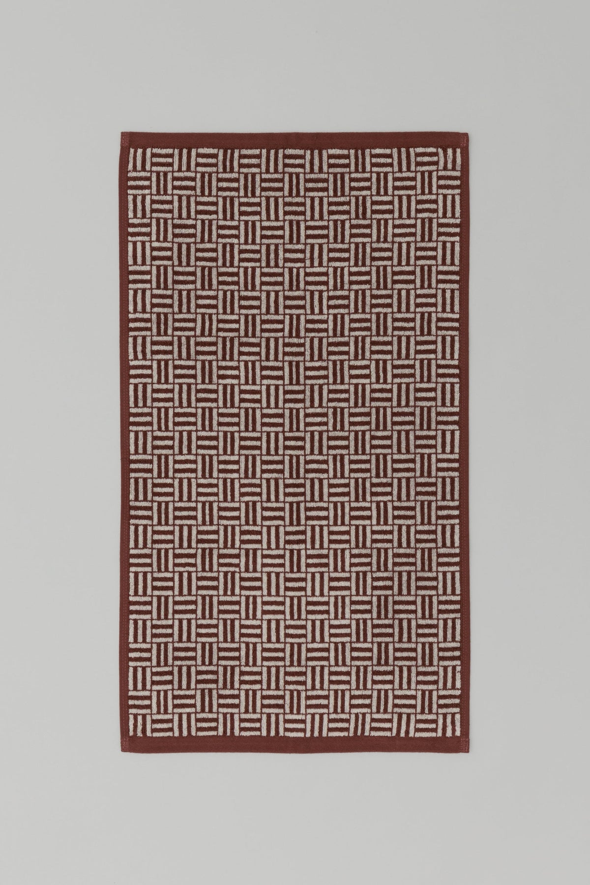 BAINA Torrens Hand Towel in Mudbrick & Crème, flat lay